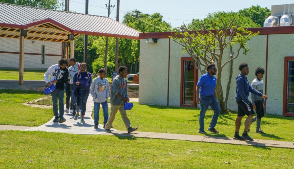 Students walking between campus buildings at Southwestern Christian College in Terrell, Texas